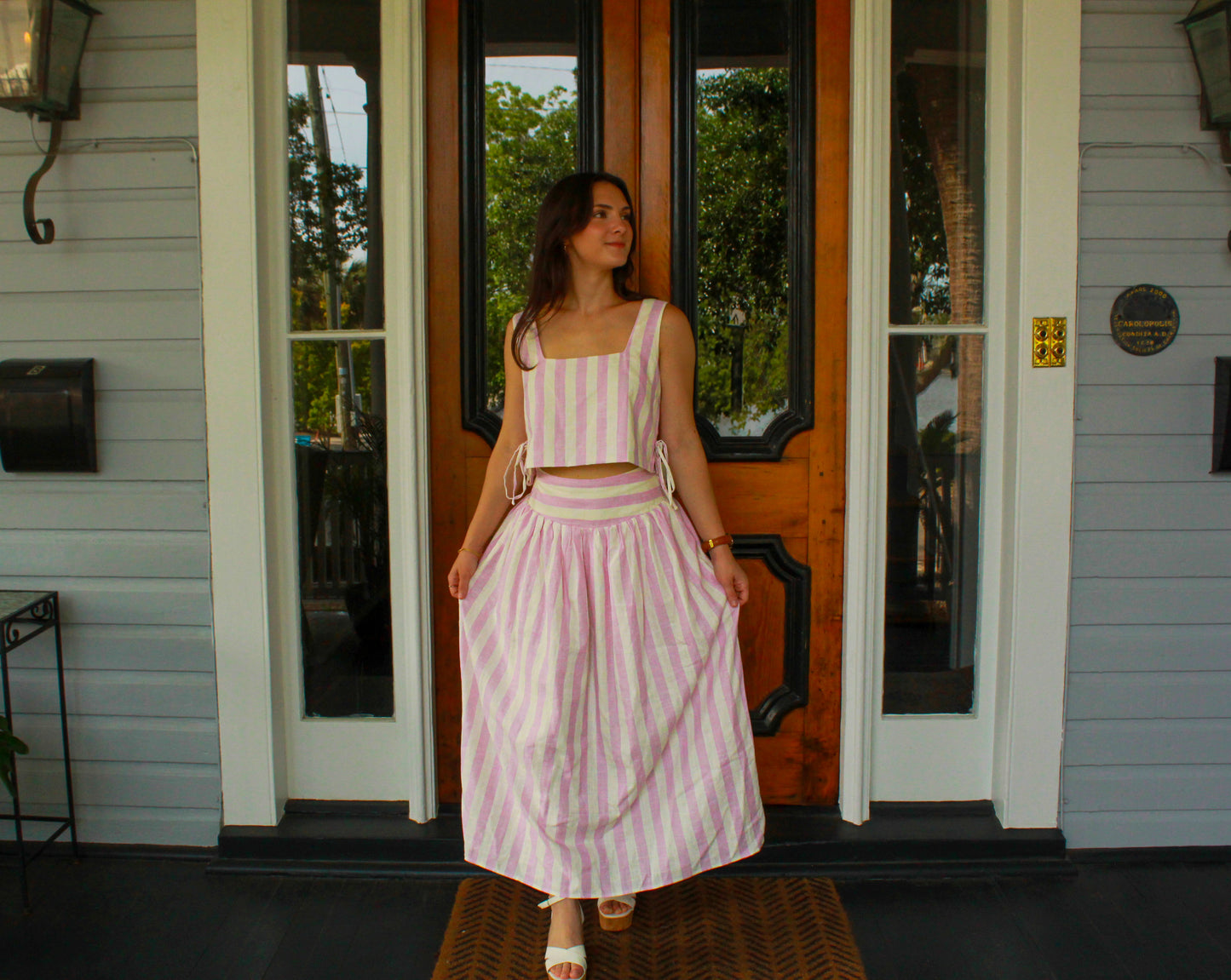 Pink and white striped two-piece set with crop top and long skirt, perfect for summer outings.