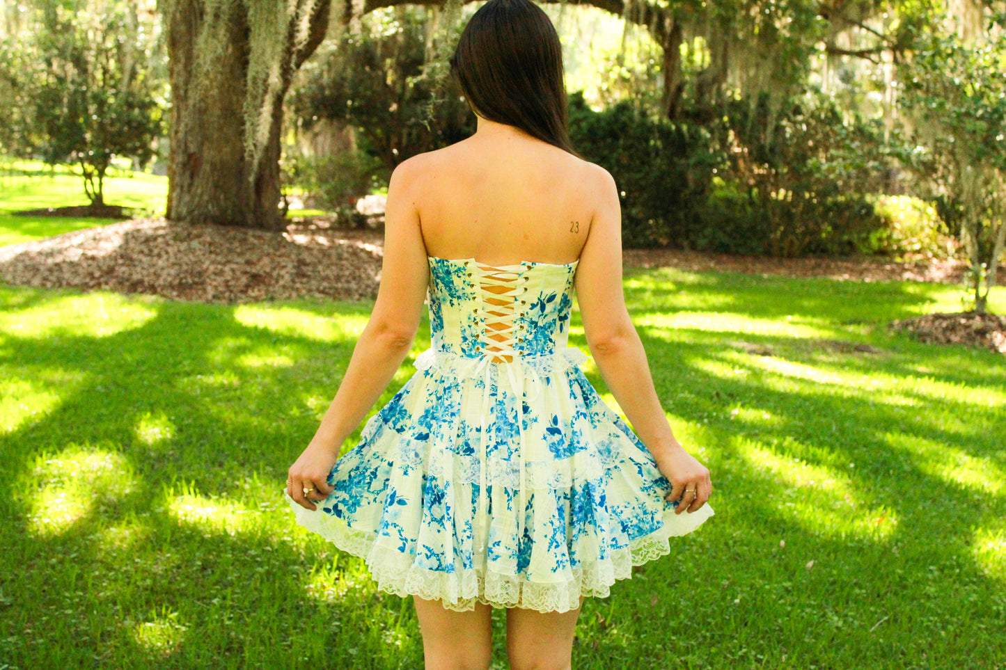 Floral print strapless dress with lace trim, featuring a corset back in blue and white, ideal for summer outings.