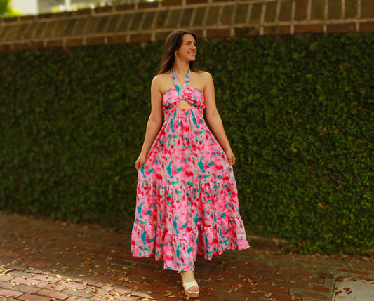 Vibrant pink and blue tie-dye maxi dress with a halter neckline and ruffled hem, perfect for summer.