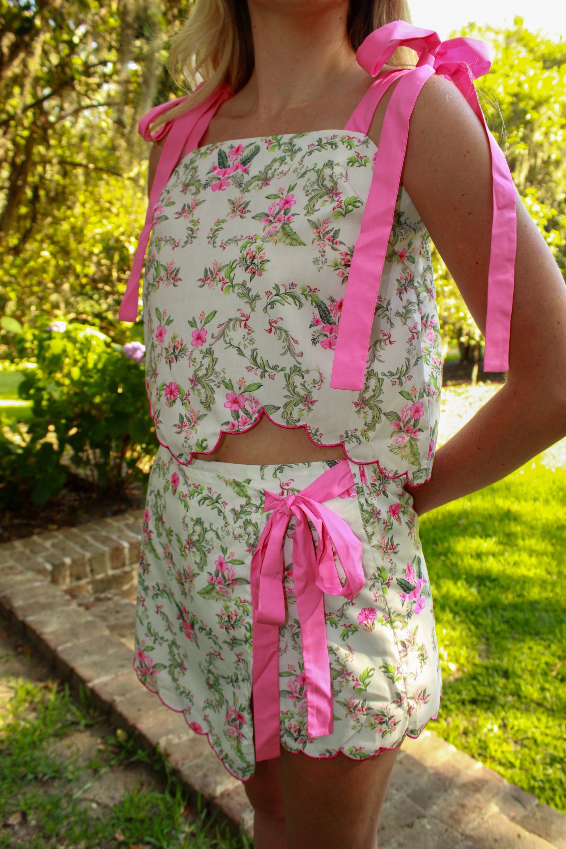 Floral two-piece set featuring a cropped top and shorts with pink ribbon details.