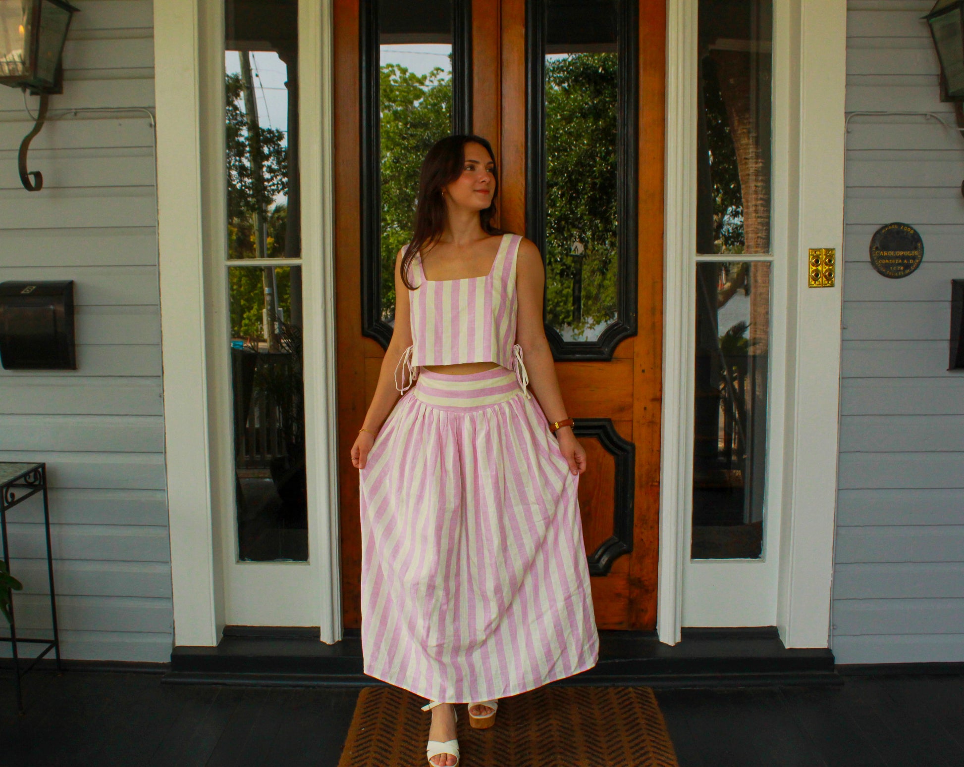 Pink and white striped two-piece set with crop top and long skirt, perfect for summer outings.