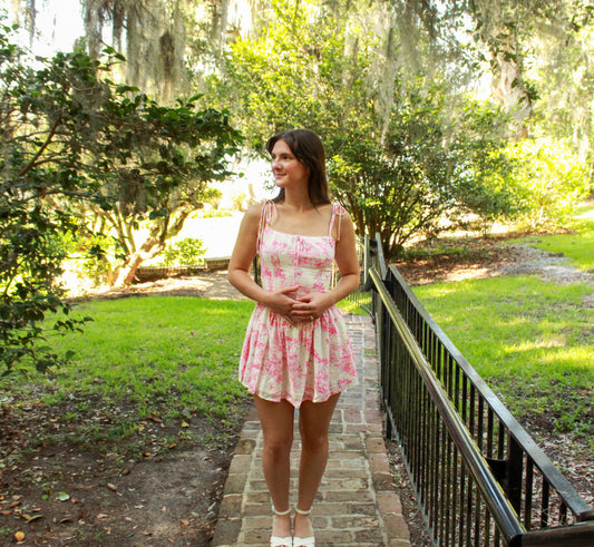 Light pink floral summer dress with adjustable straps, perfect for casual outings or beach days.
