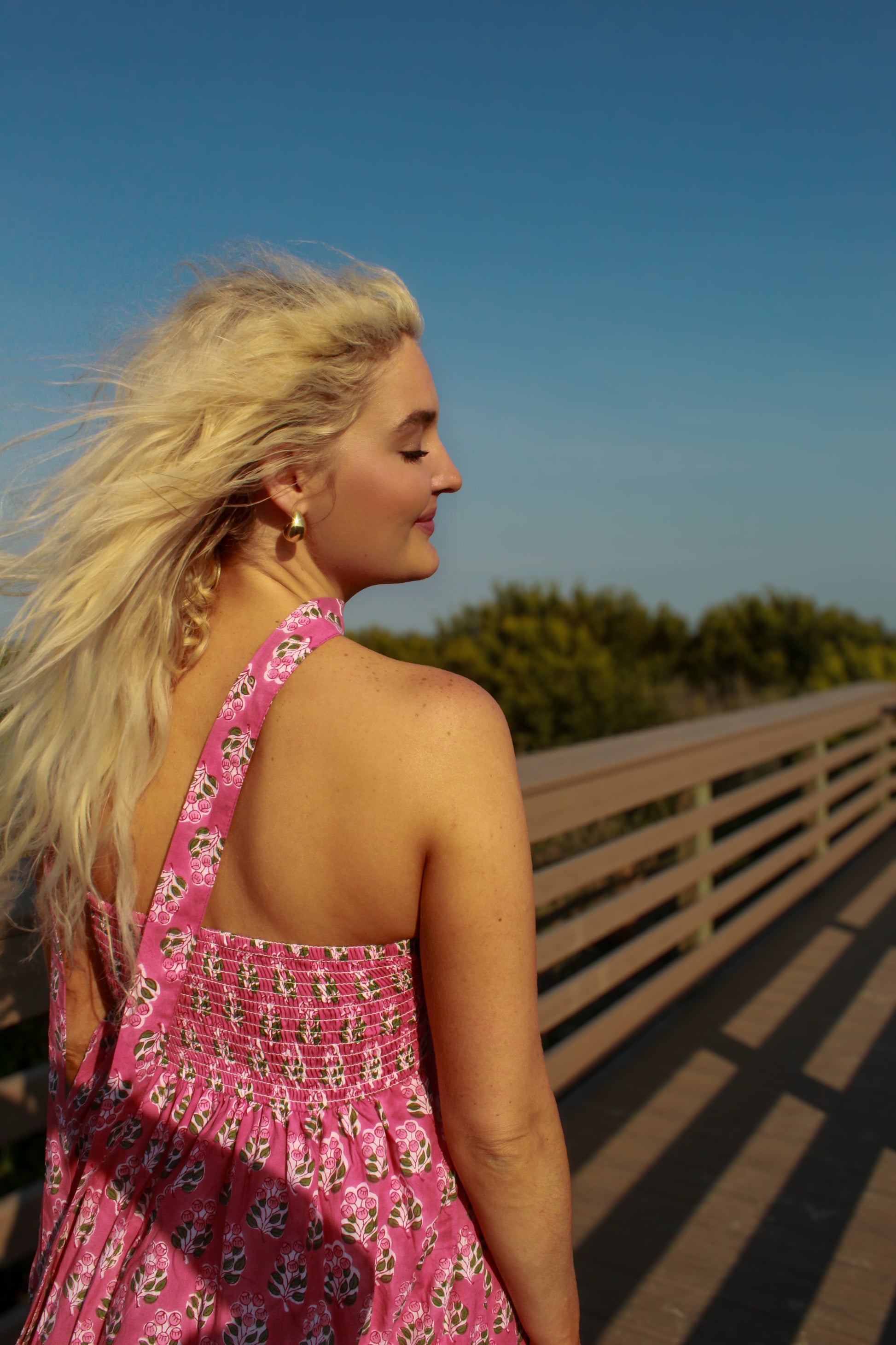 Pink floral sundress with smocked back, perfect for summer outings and casual wear.
