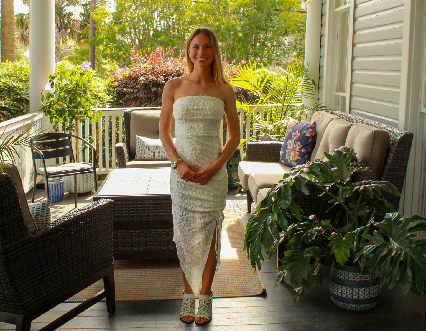 Elegant strapless white lace dress with a thigh-high slit, perfect for summer occasions.