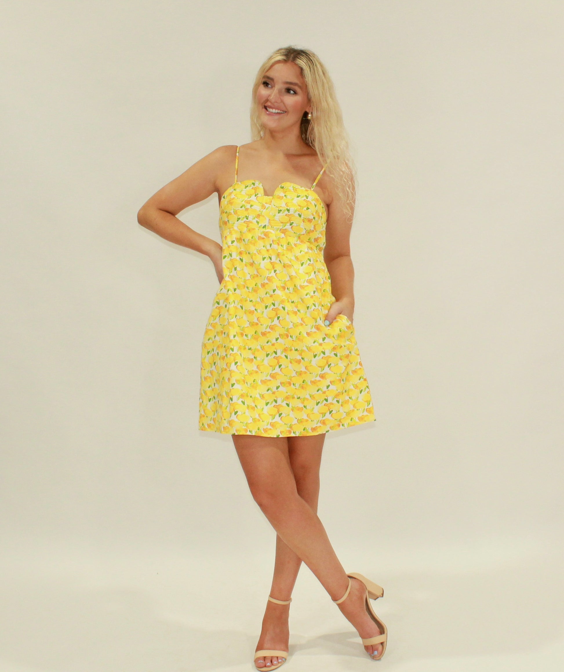 Yellow lemon print sundress with adjustable straps and pockets, perfect for summer outings.