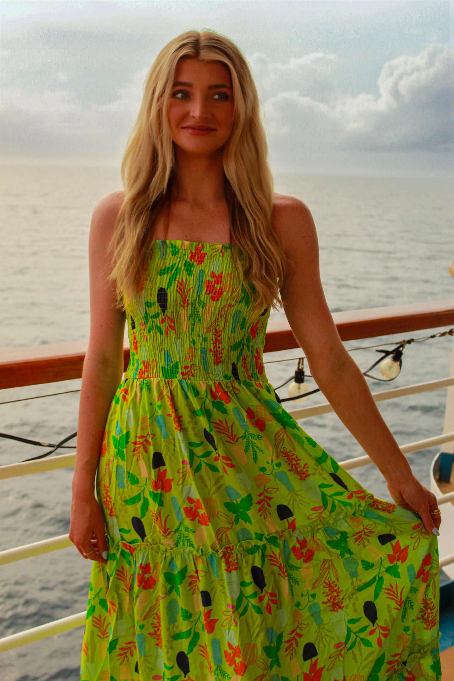 Vibrant green floral maxi dress with smocked bodice, perfect for summer outings or beach vacations.