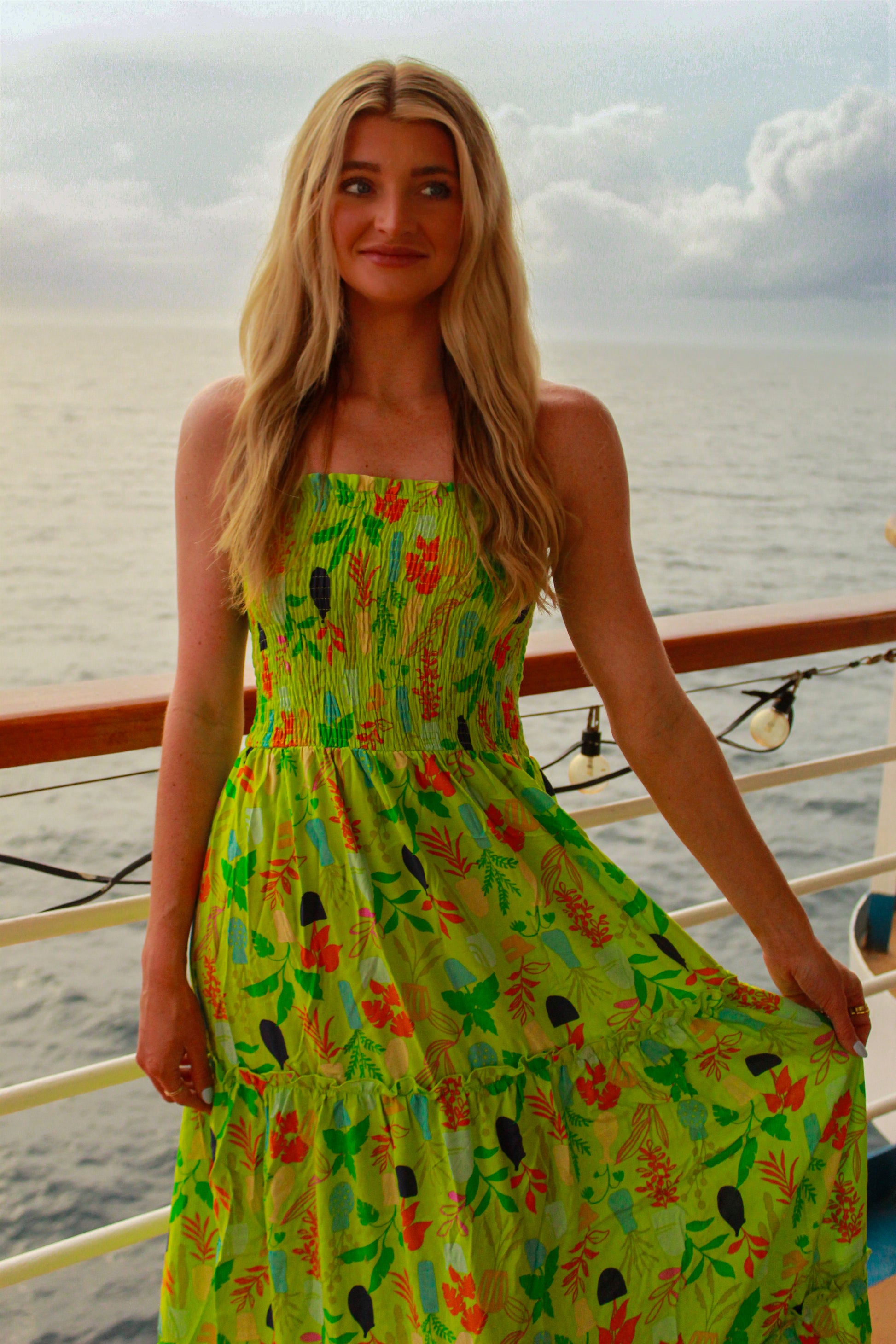 Vibrant green floral maxi dress with smocked bodice, perfect for summer outings or beach vacations.