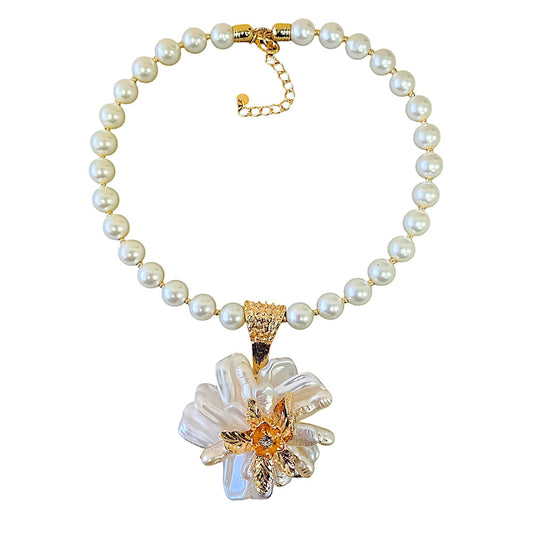 Pearl necklace with a floral pendant on a white background
