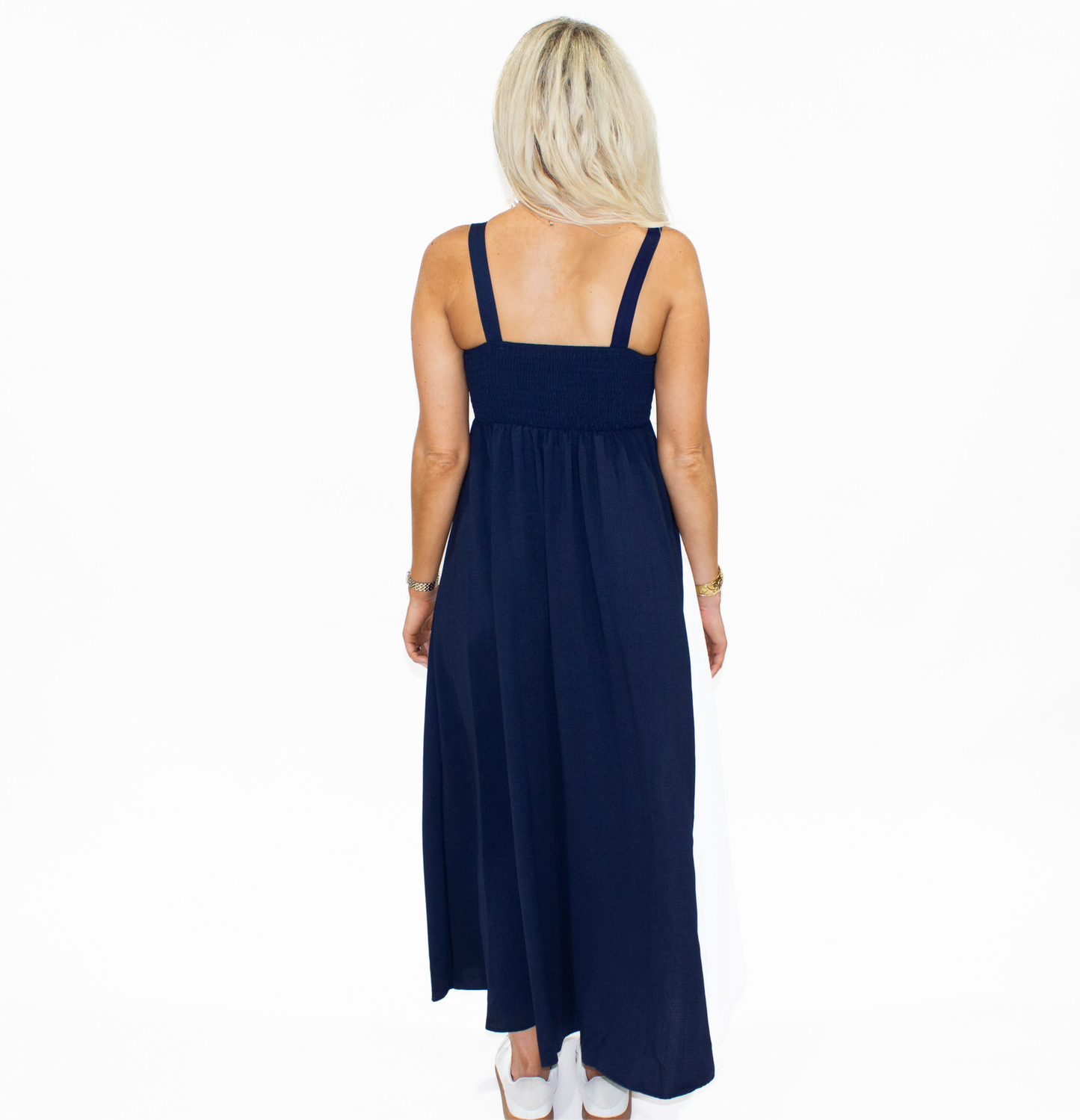 Woman wearing a navy blue dress on a white background