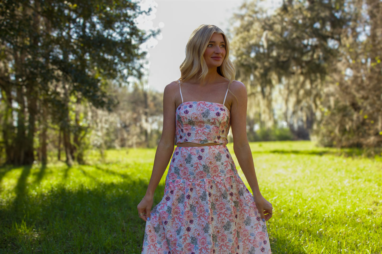 Floral two-piece dress in pastel colors, featuring a crop top and flowing skirt, perfect for spring outings.