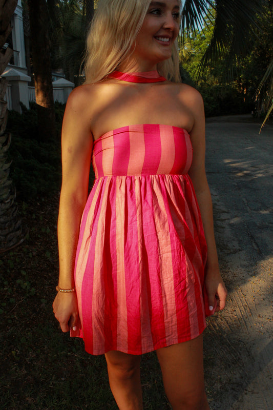 Strapless pink striped summer dress made from lightweight fabric, perfect for casual outings.