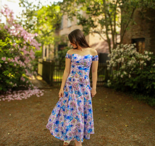 Off-shoulder floral maxi dress in blue and purple, made of lightweight fabric, perfect for summer occasions.