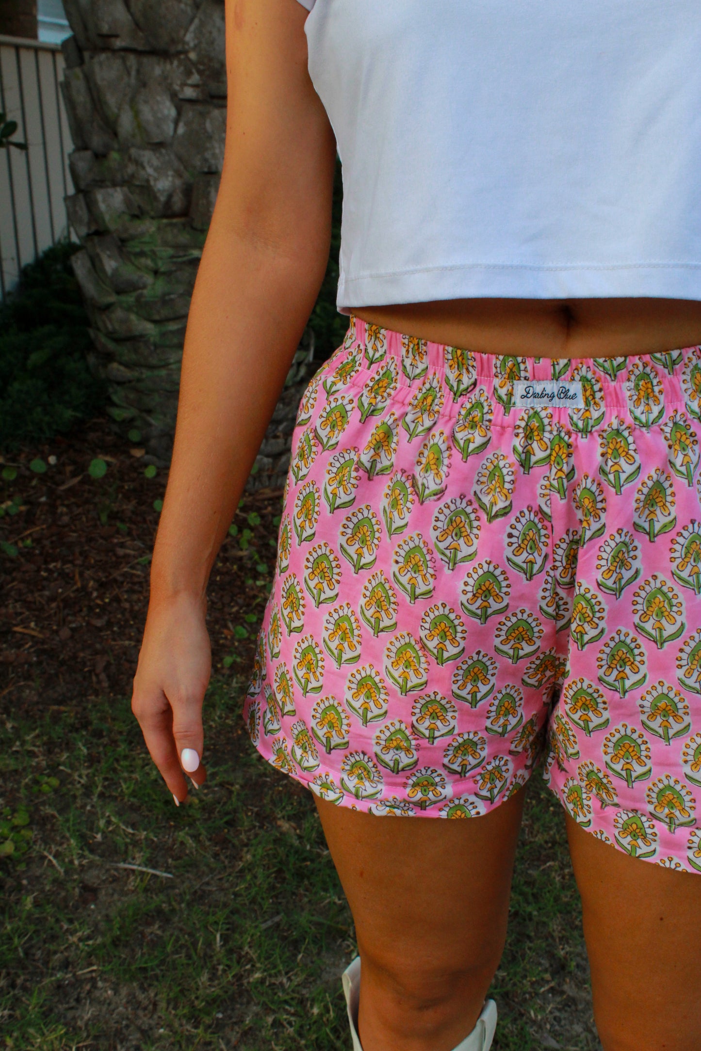 Pink floral print shorts made of lightweight cotton, perfect for casual summer outings.