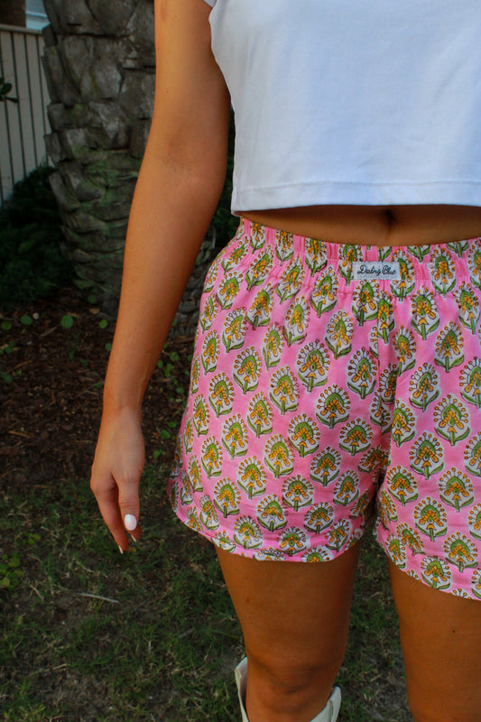 Pink floral print shorts made of lightweight cotton, perfect for casual summer outings.