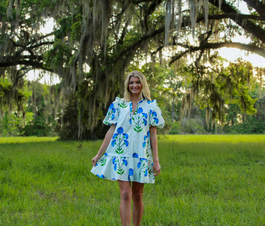 Floral print short dress in white and blue, featuring puff sleeves and a tiered skirt, perfect for summer outings.