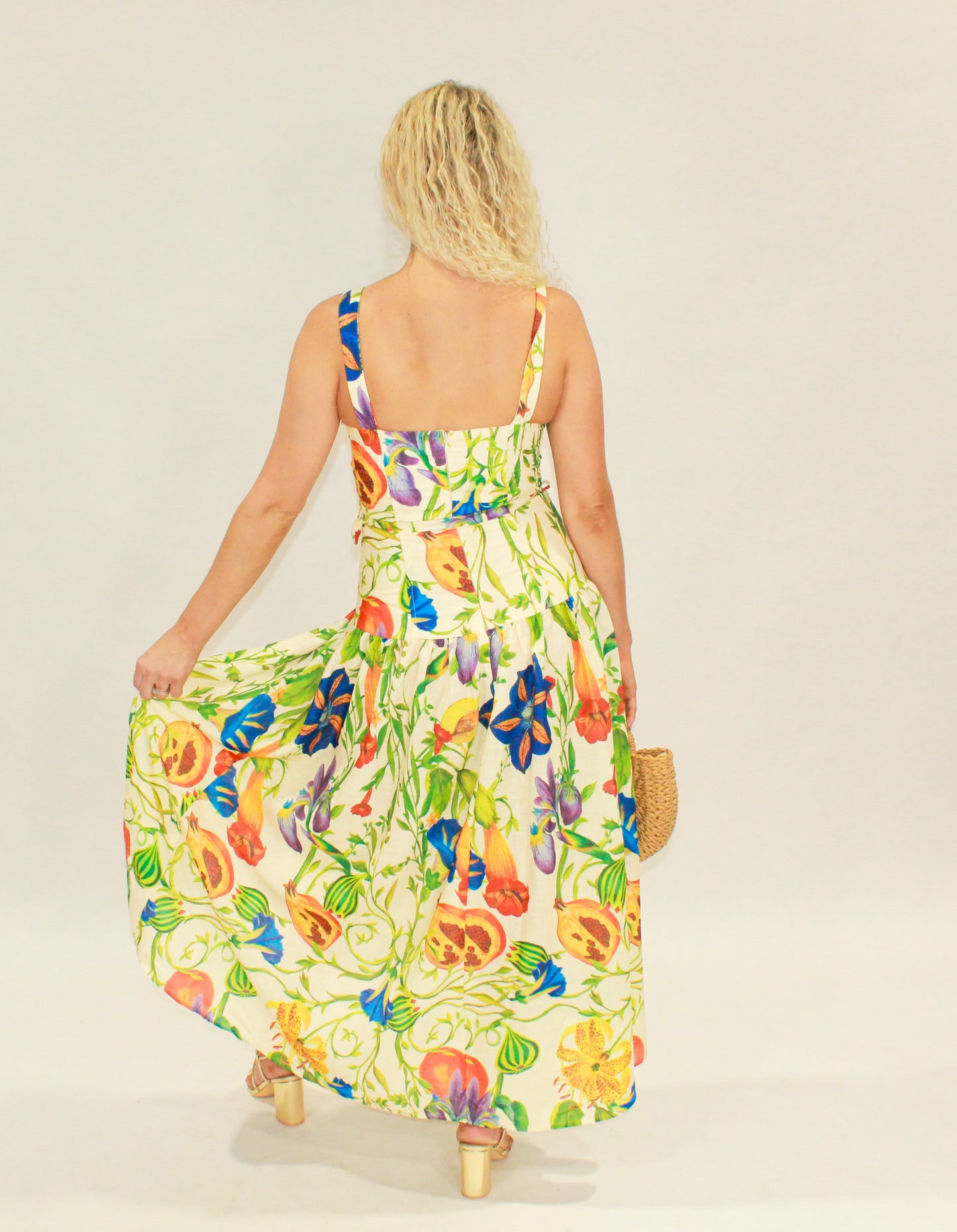Floral maxi dress in vibrant colors, featuring a flowy skirt and adjustable straps, perfect for summer.