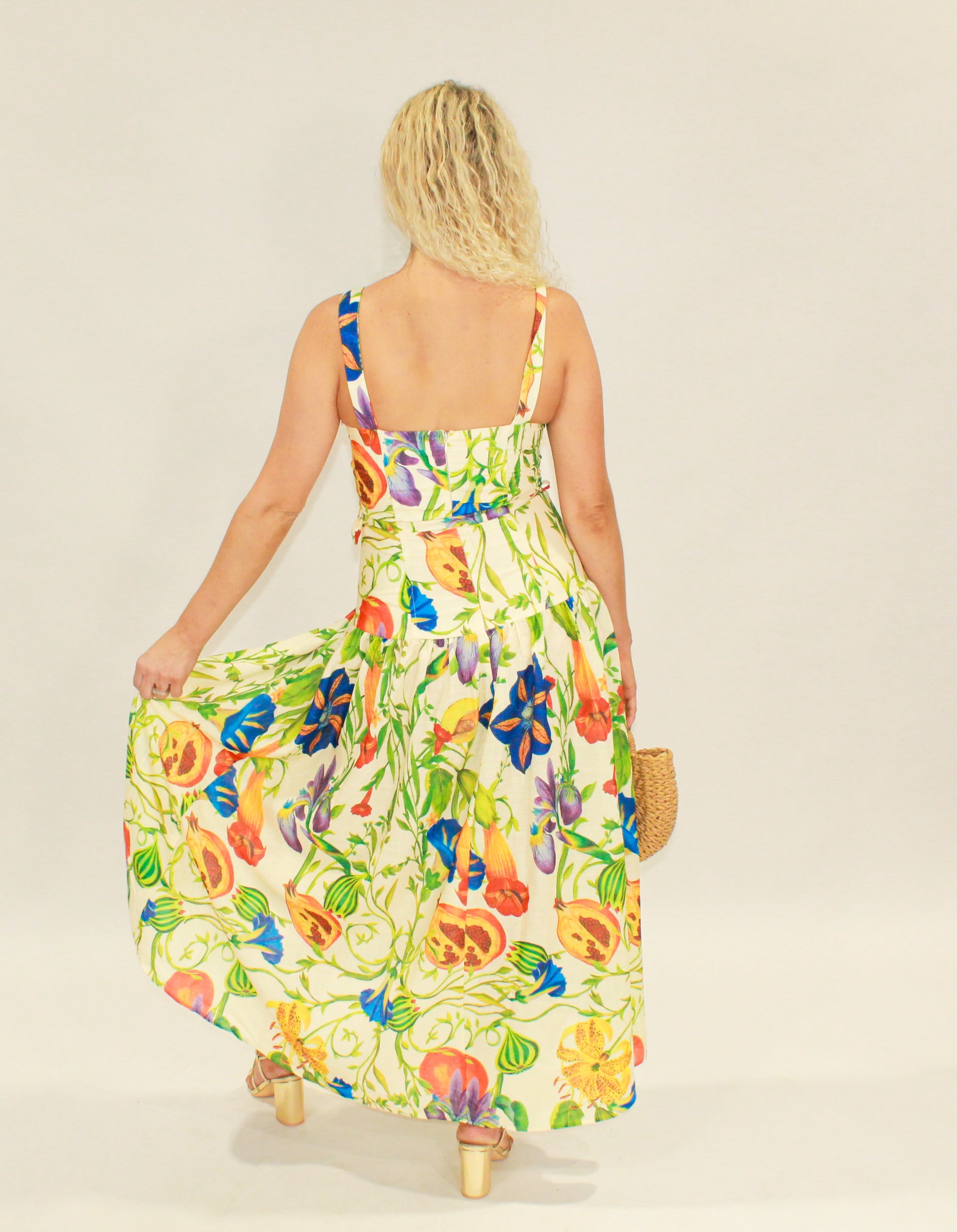 Floral maxi dress in vibrant colors, featuring a flowy skirt and adjustable straps, perfect for summer.