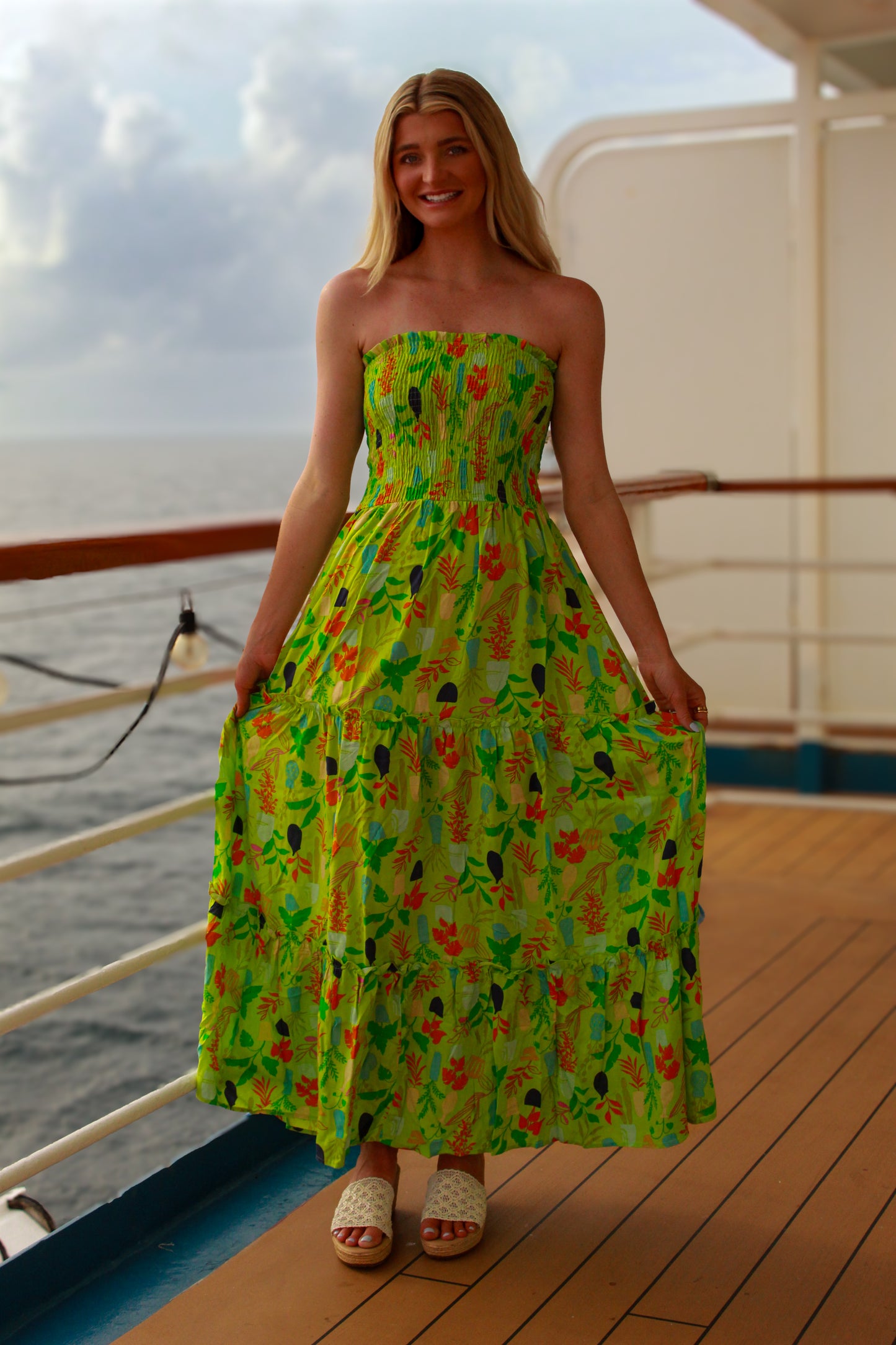 Strapless green floral maxi dress with smocked bodice, perfect for summer outings and vacations.