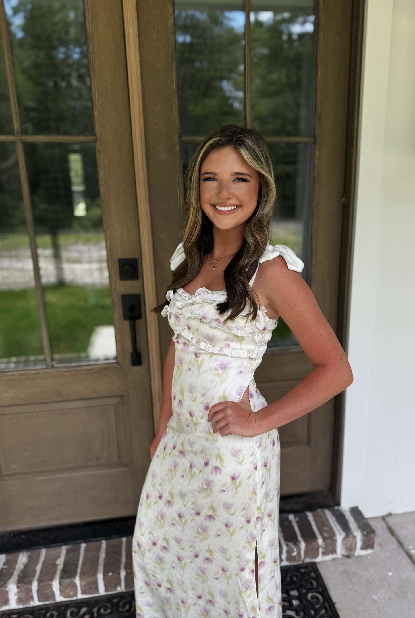Floral summer dress in white with purple accents and ruffled details, perfect for casual occasions.