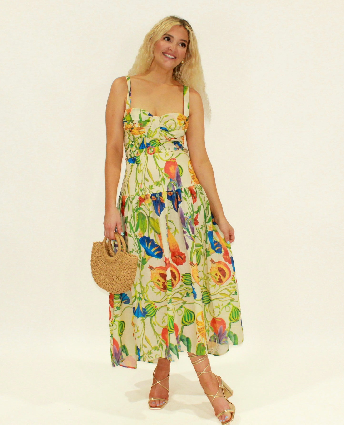 Floral print midi dress in yellow, made of lightweight fabric, perfect for summer occasions.