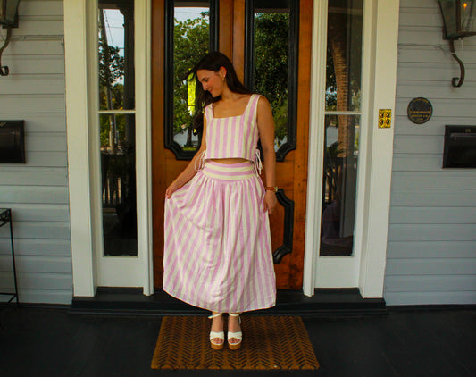 Women's pink and white striped two-piece set, featuring a cropped top and flowy skirt, perfect for summer outings.