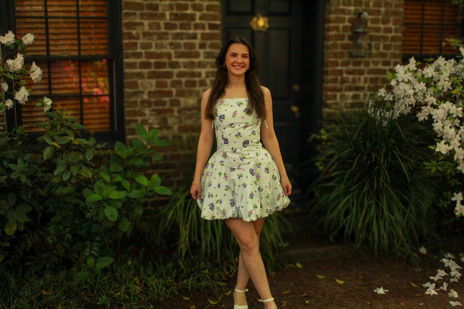 Floral print sundress in white and purple, made of lightweight fabric, perfect for summer outings.