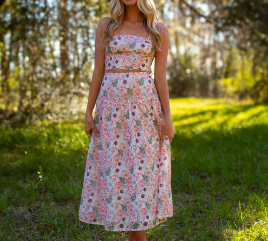 Floral two-piece dress set featuring a strapless crop top and flowing skirt in pastel colors.
