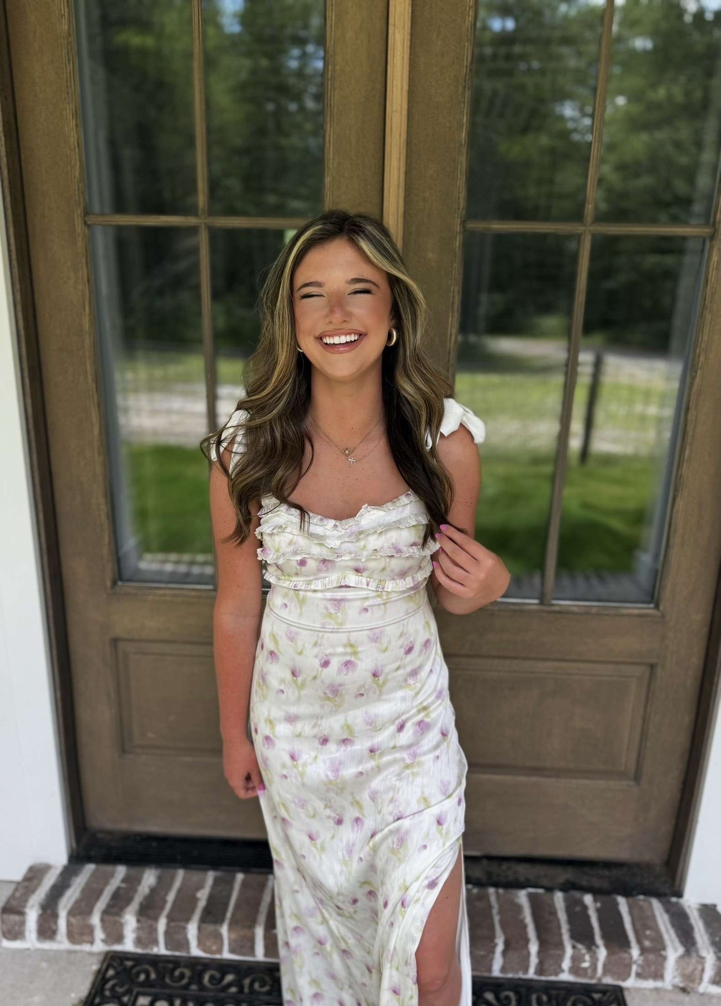 Floral print maxi dress in white and lavender, featuring ruffle details and a thigh-high slit.