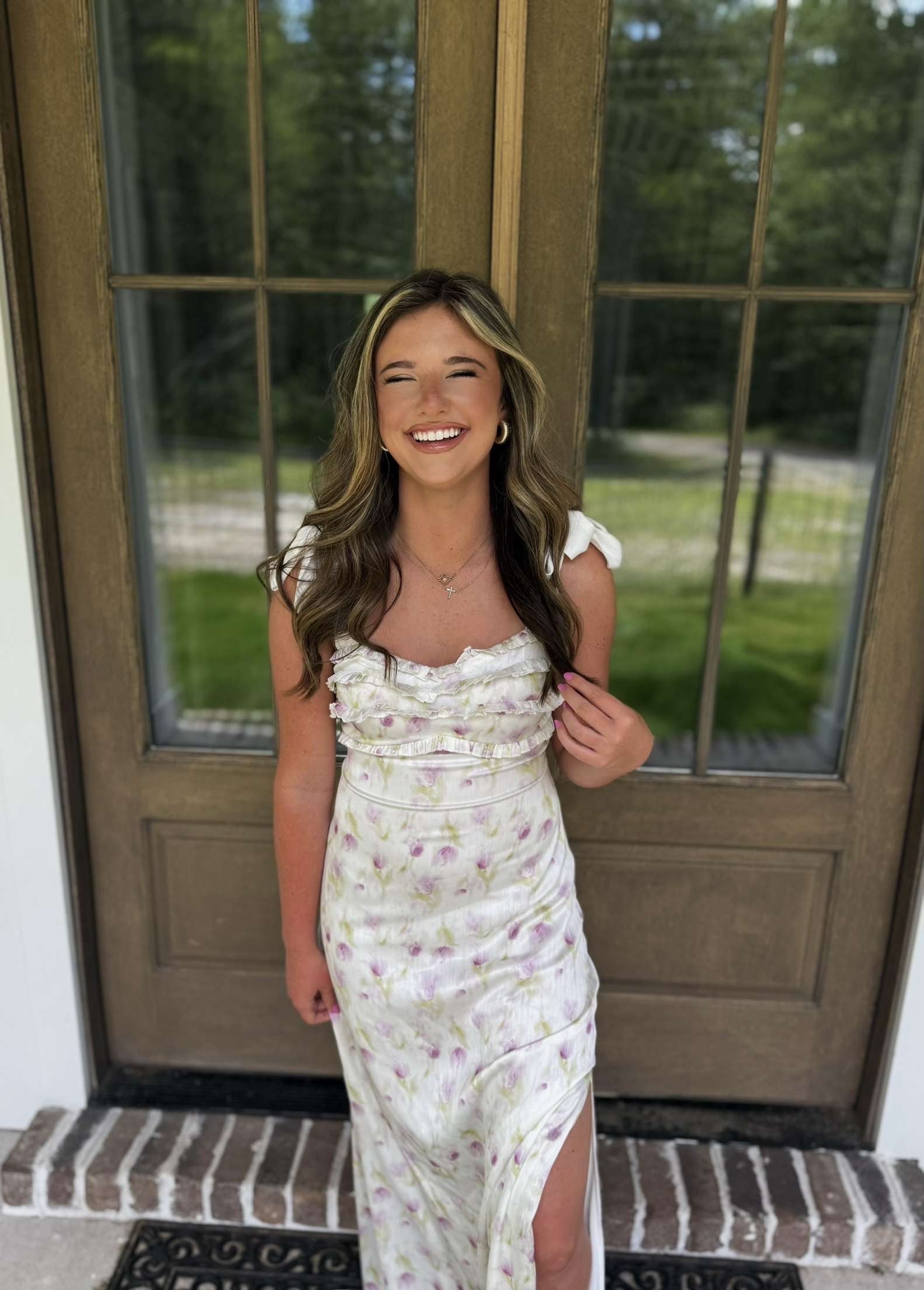 Floral print maxi dress in white and lavender, featuring ruffle details and a thigh-high slit.
