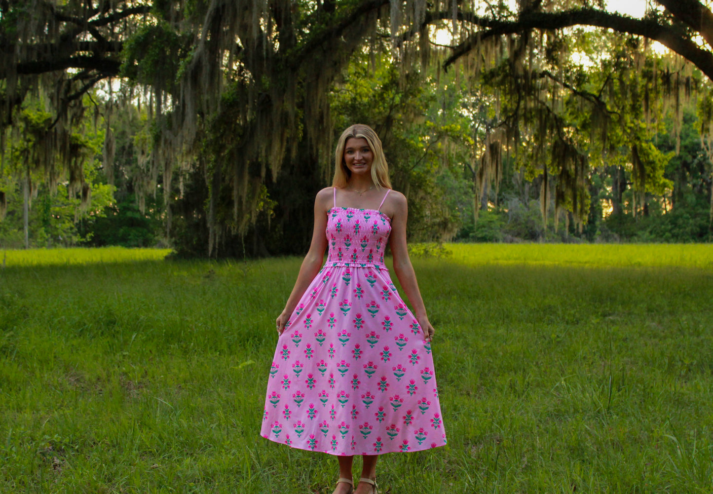 Pink floral maxi dress with smocked bodice and spaghetti straps, perfect for summer outings.