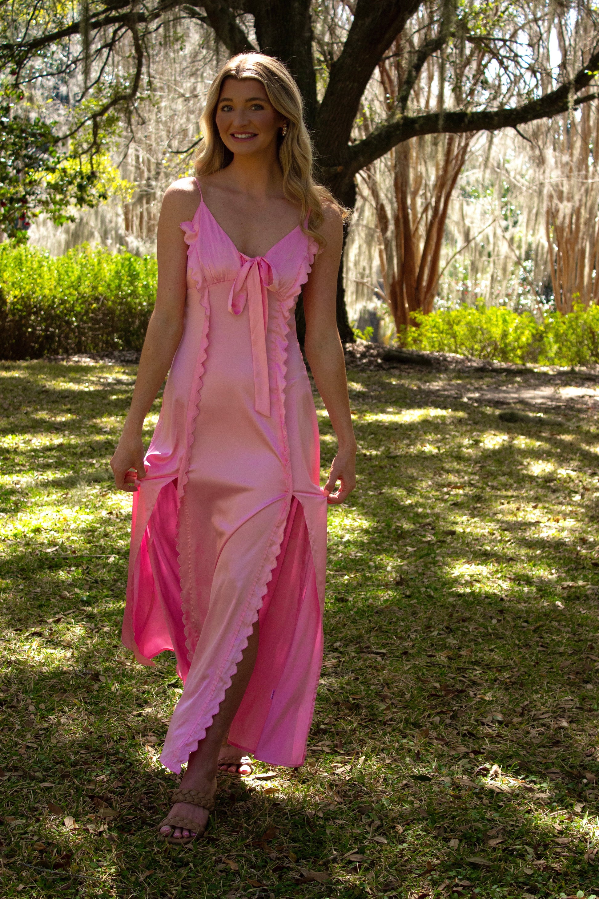 Light pink satin maxi dress with ruffle details and tie front, perfect for summer outings.