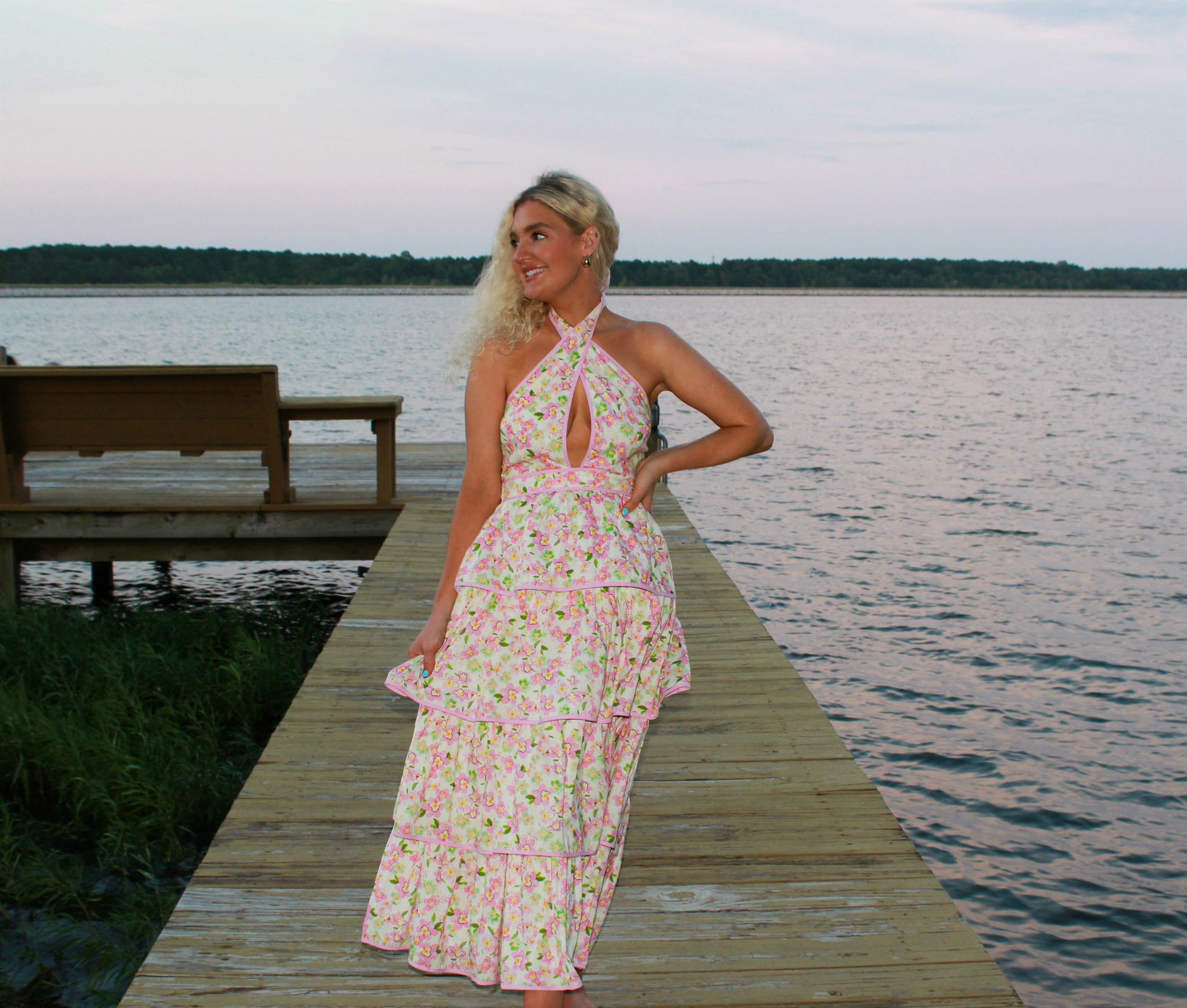 Floral maxi dress in pink and white, with a halter neck and tiered ruffles, perfect for summer events.