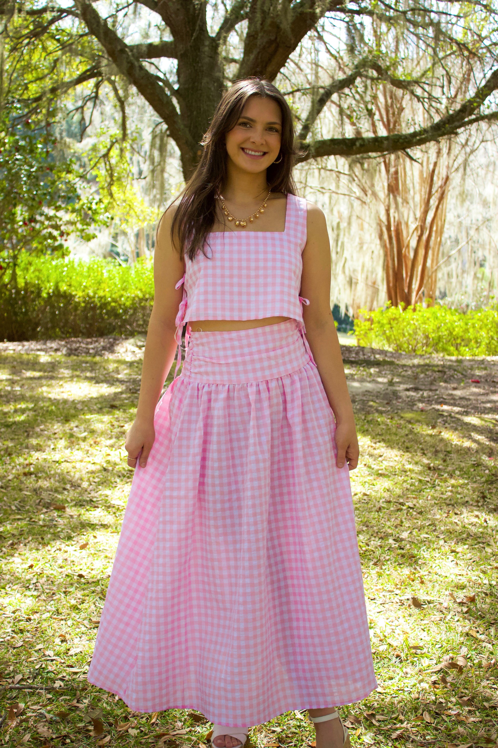 Pink gingham two-piece crop top and maxi skirt set made of lightweight cotton, perfect for summer outings.