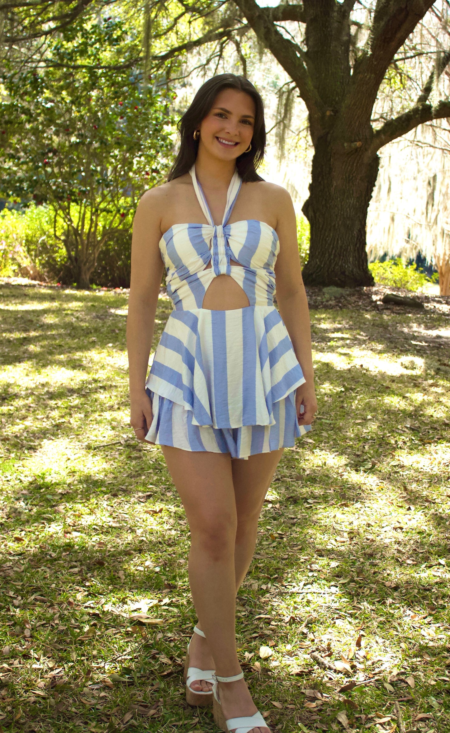 Blue and white striped halter dress with cutout, perfect for summer days outdoors.