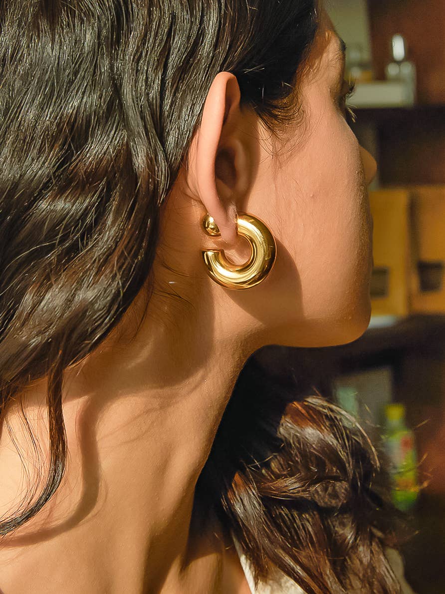Gold hoop earrings with a contemporary design, perfect for adding elegance to any outfit.