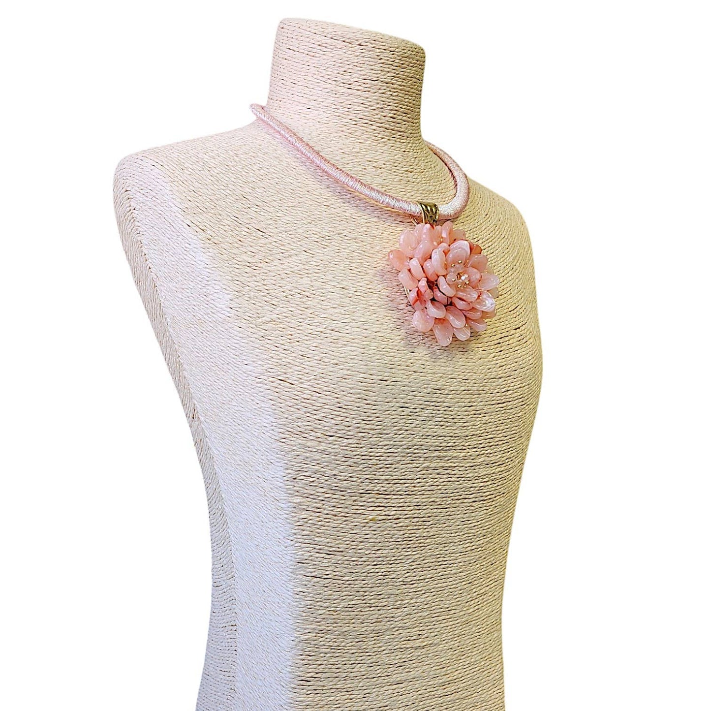Elegant pink flower necklace with a beaded cord, perfect for adding a feminine touch to any outfit.