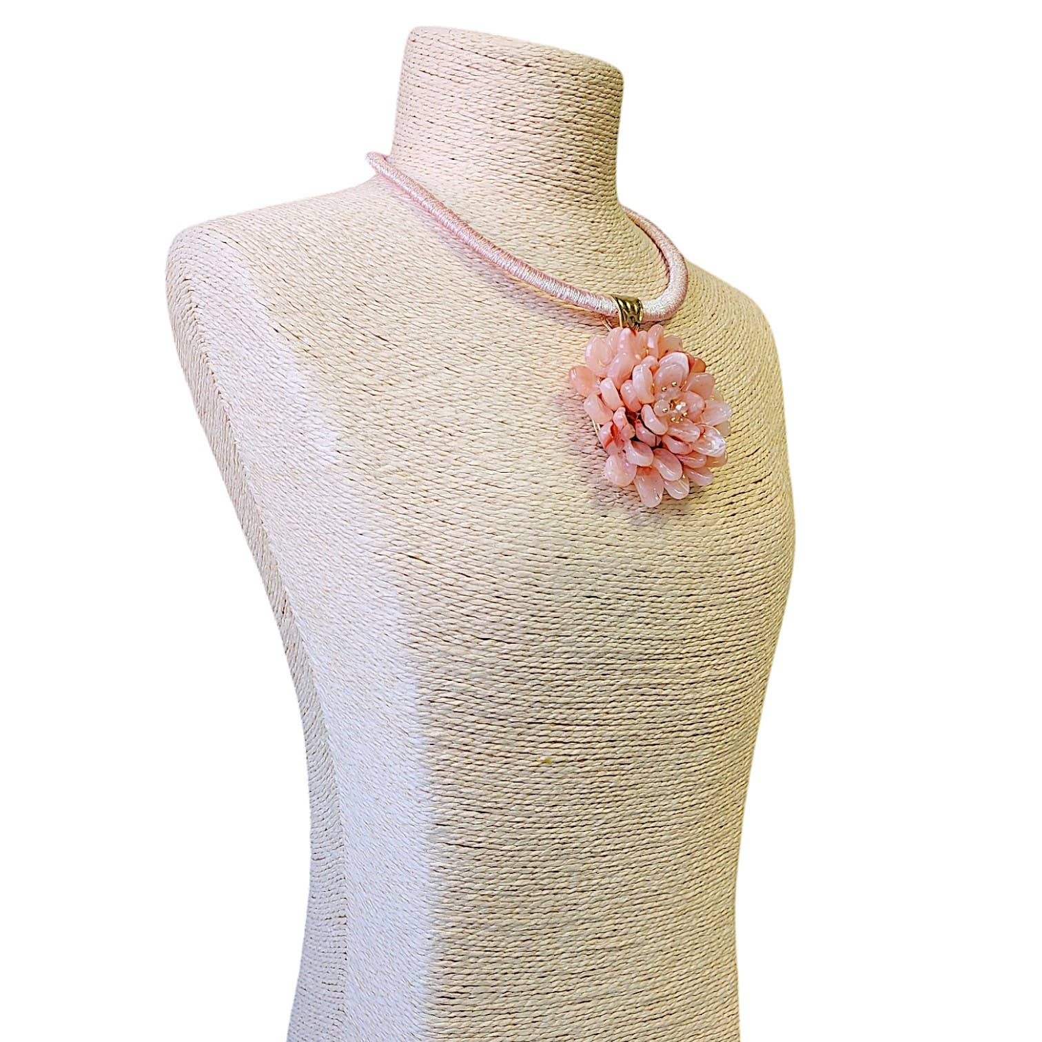 Elegant pink flower necklace with a beaded cord, perfect for adding a feminine touch to any outfit.
