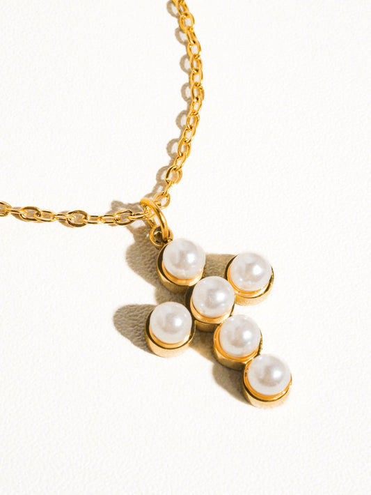 Elegant gold chain necklace featuring a pendant with six faux pearls for a chic look.